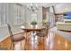 A bright breakfast nook features hardwood floors, a chandelier, and large windows at 123 Fielding Rdg, Peachtree City, GA 30269