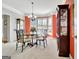 Dining area with a glass table, metal chairs, bay window and a hutch for displaying dishes at 123 Fielding Rdg, Peachtree City, GA 30269