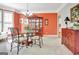 Traditional dining room featuring a glass table, wrought iron chairs and a built in china cabinet at 123 Fielding Rdg, Peachtree City, GA 30269