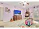 Fun living room with a colorful rug, jukebox, flat screen tv and beachy decor at 123 Fielding Rdg, Peachtree City, GA 30269