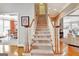 Bright staircase with carpeted steps and white banisters leads to the upper level at 123 Fielding Rdg, Peachtree City, GA 30269