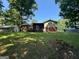 Spacious backyard with lush green lawn and a screened-in porch at 3859 Rosedale Ln, Douglasville, GA 30135