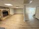 Open basement featuring a stone fireplace and wood-look flooring at 3859 Rosedale Ln, Douglasville, GA 30135