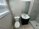 Modern bathroom featuring a tiled shower, black vanity, and new toilet at 3859 Rosedale Ln, Douglasville, GA 30135