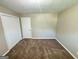 Cozy bedroom featuring plush carpet, neutral walls, and ample closet space at 3859 Rosedale Ln, Douglasville, GA 30135
