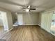 Open living room featuring wood-look floors, stairs to the second floor, and access to the back deck at 3859 Rosedale Ln, Douglasville, GA 30135