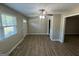 Bright living room with wood-look flooring, a ceiling fan, and lots of natural light from the window at 3859 Rosedale Ln, Douglasville, GA 30135