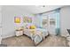 Bright bedroom with carpeted floors, a cozy bed, stylish bedside table, and natural light at 1653 Sungrown Way, Mcdonough, GA 30253
