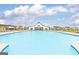 Large community pool with ample lounge seating and a view of the community center at 1653 Sungrown Way, Mcdonough, GA 30253