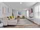 Bright living room features modern decor, ample seating, and a decorative fireplace at 1653 Sungrown Way, Mcdonough, GA 30253
