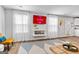 Modern living room featuring a cozy fireplace, large windows and stylish decor at 1653 Sungrown Way, Mcdonough, GA 30253