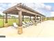 Community pool featuring covered lounge chairs and fenced perimeter at 1653 Sungrown Way, Mcdonough, GA 30253