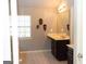 Well-lit bathroom with a vanity, decorative masks, a large mirror, and ceramic tile floors at 7625 Bowhead Ct, Fairburn, GA 30213