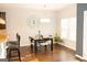 Cozy breakfast nook featuring hardwood floors, a modern chandelier, and a view of the sunny backyard at 7625 Bowhead Ct, Fairburn, GA 30213