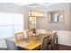 Elegant dining room featuring modern lighting, a decorative mirror, and a dining table with six chairs at 7625 Bowhead Ct, Fairburn, GA 30213