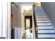 Inviting hallway with hardwood floors and staircase with dark wood trim, leading to a bright entrance at 7625 Bowhead Ct, Fairburn, GA 30213