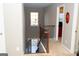 Carpeted staircase with a dark metal and wood railing leading to a hallway and view of the lower level at 7625 Bowhead Ct, Fairburn, GA 30213