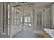 A bathroom under construction includes the frame of a shower and large windows at 114 Oak Ridge Dr, Sharpsburg, GA 30277