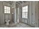 A bathroom under construction with a framed shower between two bright and sunny windows at 114 Oak Ridge Dr, Sharpsburg, GA 30277