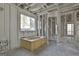 A bathroom under construction includes a standalone tub, framed shower, and large windows at 114 Oak Ridge Dr, Sharpsburg, GA 30277