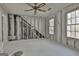 Renovation in progress in the bedroom with exposed walls, ceiling fan, and natural light streaming through two windows at 114 Oak Ridge Dr, Sharpsburg, GA 30277