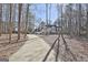 Traditional two story home featuring a long driveway surrounded by mature trees at 114 Oak Ridge Dr, Sharpsburg, GA 30277