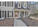Charming home boasts a welcoming front porch with classic columns and black shutters at 114 Oak Ridge Dr, Sharpsburg, GA 30277