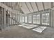 Interior under construction, with an exposed ceiling, large windows and sunlight at 114 Oak Ridge Dr, Sharpsburg, GA 30277