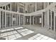 The living room exhibits architectural potential with exposed support beams, windows and staircase, ready for renovation at 114 Oak Ridge Dr, Sharpsburg, GA 30277