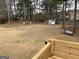 Spacious backyard featuring mature trees, a shed, and deck area at 3223 Thornecreek Dr, Douglasville, GA 30135
