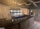 Finished basement bar with shelves, sink, refrigerator, and custom wood trim design at 3223 Thornecreek Dr, Douglasville, GA 30135