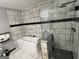 Modern bathroom with a jacuzzi tub, stand-up shower, and marble-style tiling at 3223 Thornecreek Dr, Douglasville, GA 30135