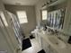 Well-lit bathroom featuring a double sink vanity, ample counter space, and a shower at 3223 Thornecreek Dr, Douglasville, GA 30135