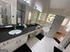 Bathroom boasts double sinks, tub, and stained glass window at 3223 Thornecreek Dr, Douglasville, GA 30135