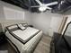 Bedroom with a ceiling fan, light grey walls, wood-look floors, and a white bed with black and white accents at 3223 Thornecreek Dr, Douglasville, GA 30135