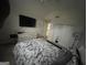 Bright bedroom featuring television, neutral walls, and closet space at 3223 Thornecreek Dr, Douglasville, GA 30135