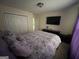 Neutral bedroom featuring television, storage, and closet space at 3223 Thornecreek Dr, Douglasville, GA 30135