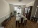 Dining room with hardwood floors, large dining table, and decorative wall molding at 3223 Thornecreek Dr, Douglasville, GA 30135