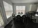 This bright dining area features a modern glass table, and kitchen access at 3223 Thornecreek Dr, Douglasville, GA 30135