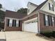 Brick home with a 2 car garage and black shutters at 3223 Thornecreek Dr, Douglasville, GA 30135