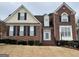 Brick home with white trim, shutters, and a well-maintained lawn at 3223 Thornecreek Dr, Douglasville, GA 30135