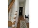 View of hallway leading to a laundry room near carpeted stairs at 3223 Thornecreek Dr, Douglasville, GA 30135
