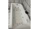 Overhead shot of jacuzzi tub with multiple jets and chrome fixtures in a tiled bathroom at 3223 Thornecreek Dr, Douglasville, GA 30135