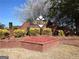 Community sign for Greythorne featuring lush landscaping and brick base at 3223 Thornecreek Dr, Douglasville, GA 30135