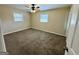 A carpeted bedroom with two windows and an overhead light with fan at 2270 Titan Ridge, Decatur, GA 30035