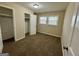 A carpeted bedroom with two windows, an overhead light, and a closet at 2270 Titan Ridge Dr, Decatur, GA 30035