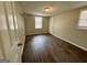 Simple bedroom with hardwood floors, a white door, and a window at 2804 Mitchell Dr, Decatur, GA 30032