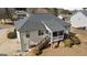 Back exterior showing a wooden deck and stairs in a spacious backyard surrounded by greenery at 391 Hickory Lake Dr, Acworth, GA 30101