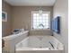 A bathtub featuring natural light and a towel rack at 391 Hickory Lake Dr, Acworth, GA 30101