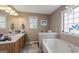 Bathroom with a soaking tub, double vanity sinks and natural light at 391 Hickory Lake Dr, Acworth, GA 30101